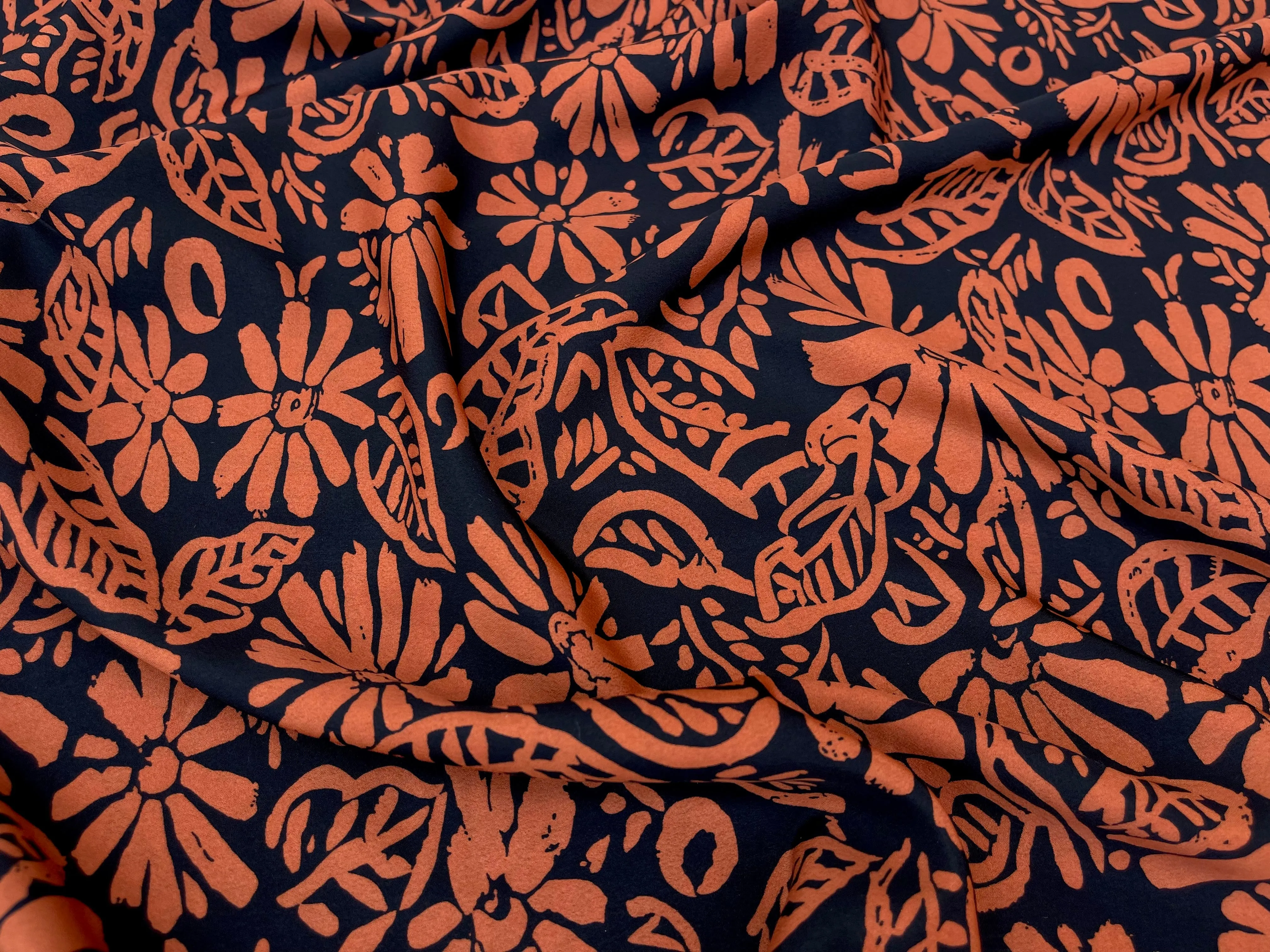 Crepe de Chine fabric by the yard - Orange paisley floral on black